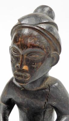 An African tribal carved figure, formed holding drum, with elaborate head dress, 34cm high. - 5