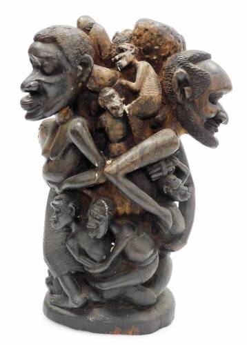 A heavily carved African tribal group, formed as many entwined figures, on a shaped base, 39cm high.