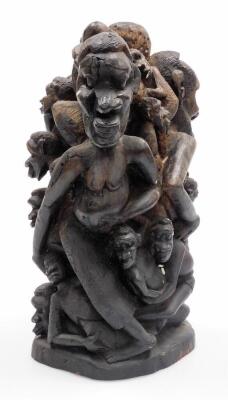 A heavily carved African tribal group, formed as many entwined figures, on a shaped base, 39cm high. - 4