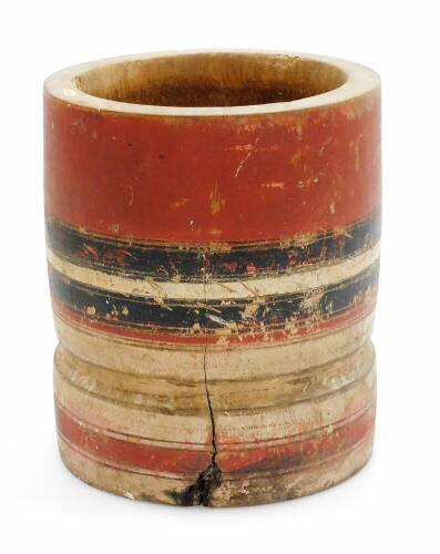 An African tribal jar, painted with a red and black banding, with plain interior, 18cm high.