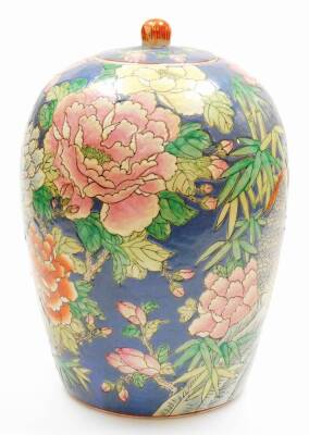 A Chinese famille rose ovoid jar and cover decorated with parakeets and chrysanthemums, bamboo etc on a blue ground, printed six character Qianlong mark to base, 20thC, 34cm high. - 2