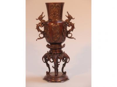 A late 19thC Chinese bronze dragon vase decorated in relief with birds