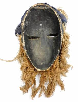 A heavily carved African tribal head, with hair and beard picked out with shells, with pierced eyes, partially painted red and black, main body, 39cm high. - 4