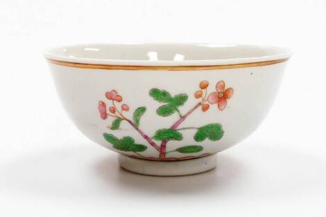 A Chinese porcelain bowl decorated in green and pink enamels, with flowering branches above a lotus petal border, double circle six character Kangxi mark, 19thC, 14cm diameter.