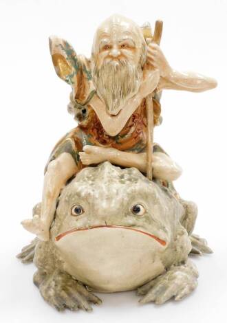 An unusual Japanese Satsuma group of a Gama Sennin seated upon his giant toad, Meiji period. 28cm high.