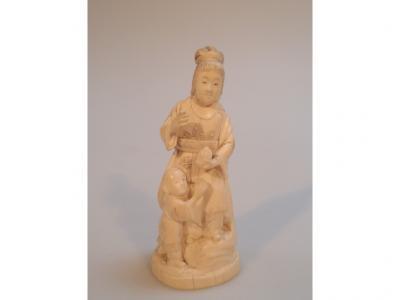 A Japanese carved ivory Okimono figure group of a woman and child