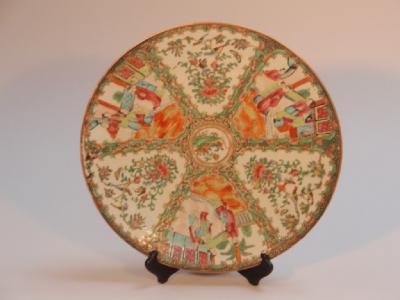 A 19thC Chinese famille rose plate painted with three reserves of figures