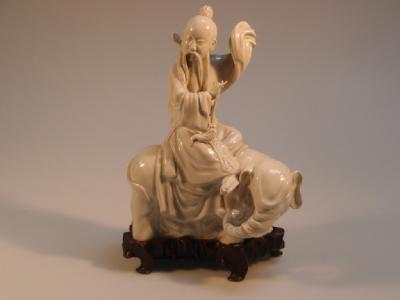 A 19thC Chinese blanc-de-chine figure of a sage riding on an elephant