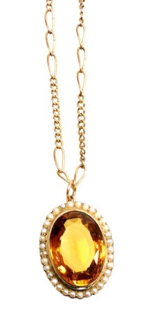 A citrine and seed pearl pendant and chain, the oval pendant with central citrine surrounded by seed pearls each in claw setting, in a yellow metal frame, 3.2cm x 2.5cm, marked 9ct, on a fancy link chain, yellow metal, unmarked, 44cm long overall, 17.6g a