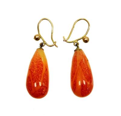 A pair of orange hardstone drop earrings, each on a yellow metal wire frame, unmarked, 5.6g all in.