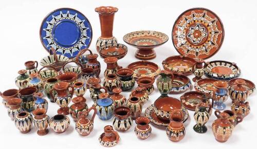 A large collection of Troyan brown earthenware glazed pottery, to include vase, 18cm high, other vases, dishes, plates, baskets, etc., some green glazed, etc. (a quantity)