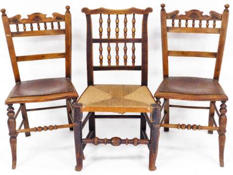 A 19thC Lancashire style elm and rush seated spindle back chair, with ear shaped cresting rail, double spindle back, rush seat and turned front legs, joined by a horizontal front stretcher, 90cm high, and a further pair of country dining chairs, with turn