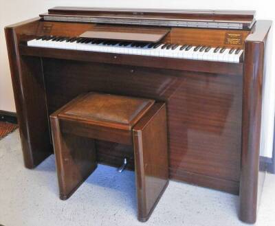 An Eavestaff "mini piano", in shaped Art Deco case, with articulated music rest, 92cm high, 142cm wide, 46cm deep, with leather topped stool.