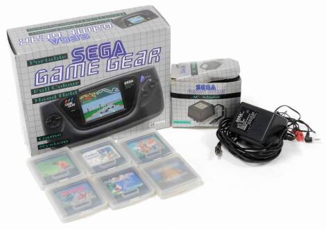 A boxed Sega Game Gear games console, with boxed AC adapter, quantity of games in outer game gear plastic boxes, to include World Class Leader Board Golf, Shinobi, Sonic The Hedgehog, Mickey Mouse Castle of Illusion, etc. (a quantity)
