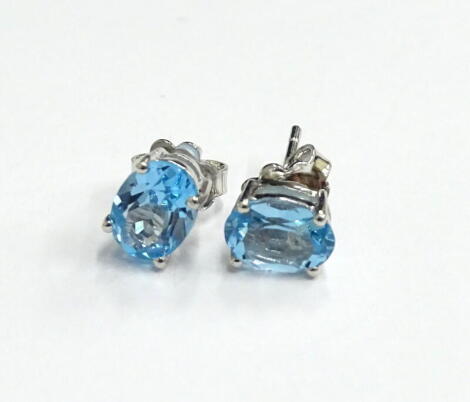 A pair of blue topaz earrings, with butterfly backs, in silver, 3.8g all in.