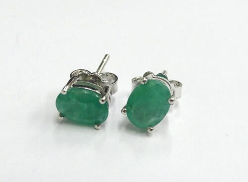 A pair of emerald stud earrings, each with butterfly backs, in silver, 2.6g all in.