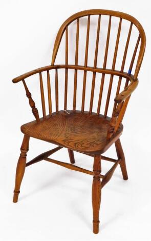 Taylor (Grantham). A 19thC low back Windsor chair, with plain spindles, C shaped arms, turned arm supports and ring turned front legs joined by an H stretcher, stamped to the seat, 92cm high.