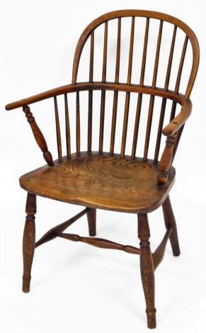 A 19thC low back Windsor chair, with plain spindles, pierced back splat, C shaped arms, turned arm supports, shaped seat, double ring turned front legs and H stretcher, 89cm high.