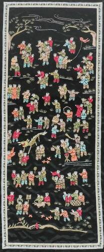 A 20thC Chinese silk embroidery panel depicting children at play on a black ground, 84cm x 32cm.