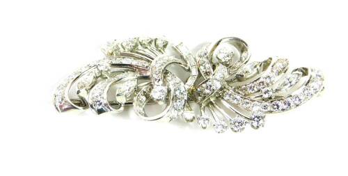 A diamond set spray brooch, of tied scrolling form, set with brilliant and baguette cut diamonds, in white metal, approx 2.6cts, 13.5g. NB. Please note we have specific instructions from the vendor to sell WITHOUT RESERVE.