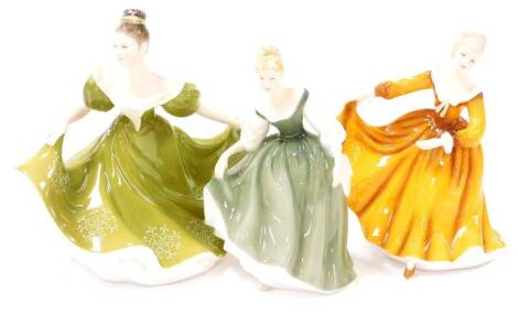 Three Royal Doulton figure, comprising Lynn HN2329, 20cm high, Kirsty part of The British Ladies Best of Classics 2004, 18cm high, and Pretty Ladies Fair Lady HN4719, 17cm high. (3)