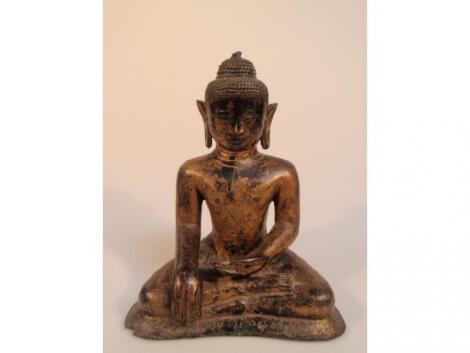 A 17thC gilt bronze figure of a seated Buddha