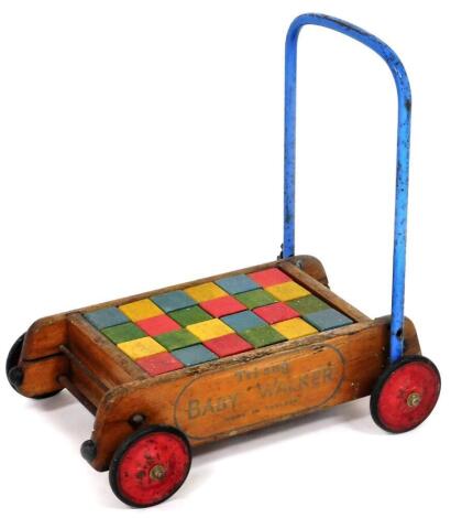 A Tri-ang baby walker with wooden building blocks.