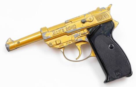 A James Bond Lonestar automatic cap gun, in gold with black handle.