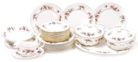 A Royal Albert Lavender Rose pattern part dinner service, comprising dinner plates, side plates, two tureens, meat plate, gravy boat and dish, a serving side plate and a bowl. (2 trays)