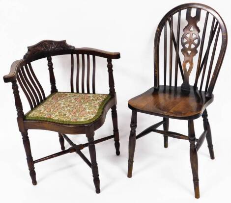 Two chairs, comprising a mahogany wheel back dining chair, the wheel back with additional six slats, on plain seat on H stretcher, 90cm high, together with a mahogany side chair with upholstered seat. The upholstery in this lot does not comply with the 1