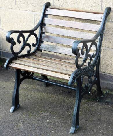 A metal framed garden slat back chair, the single chair, with shield scrolled side handles, 76cm high, 62cm wide, 60cm deep.