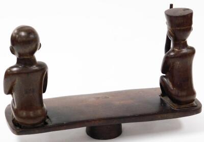 A 20thC African tribal carving, formed as two removable figures on a shaped block base, 46cm wide. - 4