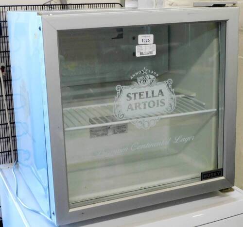 A Stella Artois table top bottle fridge, by Husky in silver, 50cm high, 50cm wide, 45cm deep.