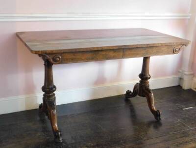 An early Victorian rosewood library table by Holland & Sons, the rectangular top above two frieze drawers, on turned end supports, carved with paterae, leaves, etc., with splayed scroll carved feet, the right hand drawer is marked 'From Holland & Sons' an - 2