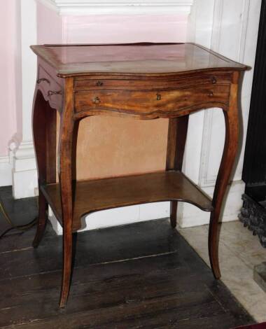 A George III mahogany fire screen writing table in the manner of John Cobb, the serpentine fronted top with a broad crossband and boxwood inlaid sides, recessed to house an adjustable fire screen, above a brush slide and a false drawer, with side drawer o