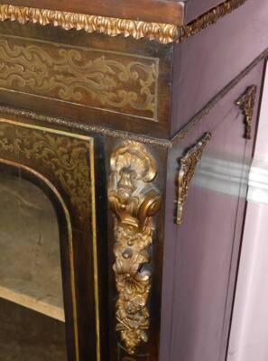 A late 19thC ebonised and brass inlaid side cabinet, with gilt metal mounts, the plain top above a leaf cast frieze, above two glazed doors enclosing a velvet lined interior, on a plinth base, 116cm high, 97cm wide, 32cm deep. - 3