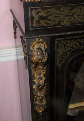 A late 19thC ebonised and brass inlaid side cabinet, with gilt metal mounts, the plain top above a leaf cast frieze, above two glazed doors enclosing a velvet lined interior, on a plinth base, 116cm high, 97cm wide, 32cm deep. - 5