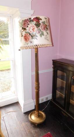 A gilt standard lamp, with a floral shade, a part fluted and leaf carved column with circular base and bun feet, 190cm high and another similar plain example. (the latter not illustrated -2)