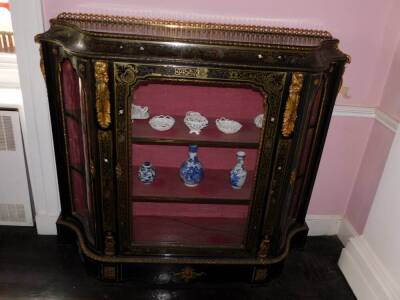 A Victorian Boulle and ebonised credenza, with a pierced gilt gallery, a concave frieze decorated with putti picked out in ivory, etc., enclosing a velvet lined interior, flanked by two further serpentine shaped doors, on a plinth base, 127cm high, 142cm - 2