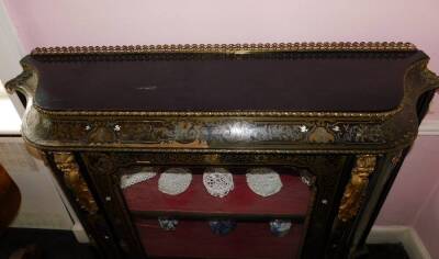 A Victorian Boulle and ebonised credenza, with a pierced gilt gallery, a concave frieze decorated with putti picked out in ivory, etc., enclosing a velvet lined interior, flanked by two further serpentine shaped doors, on a plinth base, 127cm high, 142cm - 5