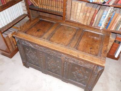 A late 17thC oak coffer, with a triple plank hinged top, the front carved with lozenges, scrolls and patera, on stiles, 60cm high, 103cm wide, 57cm deep. - 2