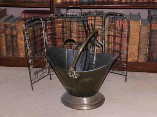 A late 19th/early 20thC brass and copper coal helmet, with swing handle, fire iron and a spark guard. (AF)