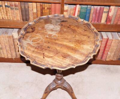 A mahogany occasional table, the circular dished pie crust top, on a turned column and tripod base, carved with leaves and paw feet, in part George III, adapted, 74cm high, 54cm wide. - 2