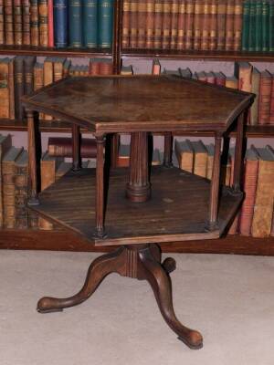 A mahogany revolving bookcase, the hexagonal top with a raised moulded gallery on reeded column supports, on a turned column and tripod base, with pad feet, constructed using old timber, 73cm high, 70cm wide.