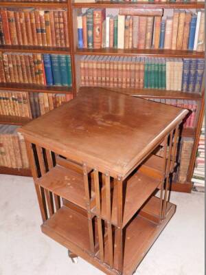 A Edwardian mahogany revolving bookcase, with slatted supports on X shaped base with ceramic castors, stencil mark for the American Patent Revolving Bookcase, manufactured by Trubner and Co Ludgate Hill London, 90cm high, 60cm wide. - 2