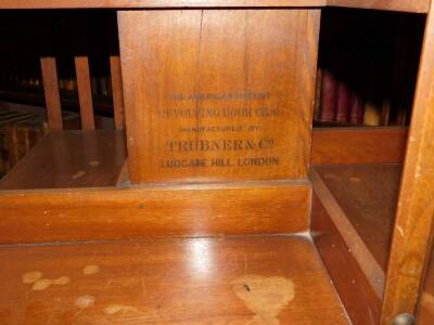 A Edwardian mahogany revolving bookcase, with slatted supports on X shaped base with ceramic castors, stencil mark for the American Patent Revolving Bookcase, manufactured by Trubner and Co Ludgate Hill London, 90cm high, 60cm wide. - 3