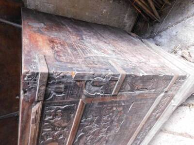 A large 17thC carved poker work walnut coffer, the lid with iron strap hinges and carved figural and lion decoration in blind fret designs, repeated to the front and with paneling and with iron bracket bound corners, on a later plinth base with shallow br - 4