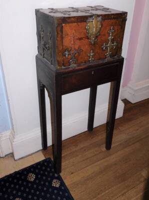 A French 17thC Kingwood Coffre Forte, with brass Gothic style straps, the hinged lid enclosing a vacant lignum veneered interior, the fall front enclosing two secret drawers, on a associated George II mahogany stand with frieze drawer on chamfered legs, 1