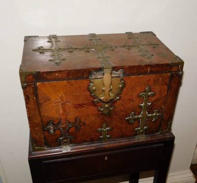 A French 17thC Kingwood Coffre Forte, with brass Gothic style straps, the hinged lid enclosing a vacant lignum veneered interior, the fall front enclosing two secret drawers, on a associated George II mahogany stand with frieze drawer on chamfered legs, 1 - 2