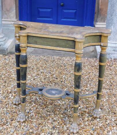 A Regency gilt and ebonised console or pier table in the manner of George Smith, the shaped top to simulate marble, with a reeded edge above a plain frieze on ring turned legs, joined by a circular undertier decorated with scrolls, on paw feet, 92cm high,